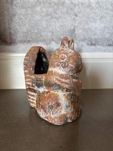 Clay potted squirrel measuring 7.5" tall, 6" deep, and 5" wide.