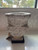 Jan Barboglio Flores y Fiestas hand cast stone container with glass insert on iron stand