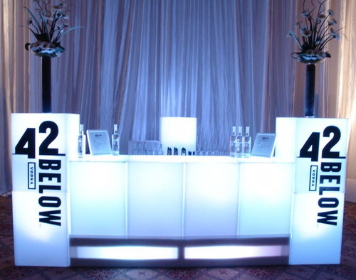 an assembled glow bar with four glow bar cubes and two taller cubes with brand logos on each side an assembled glow bar with four glow bar cubes and two taller cubes with brand logos on each side