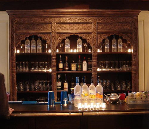 a back bar with bottles, cups and drinks a back bar with bottles, cups and drinks