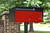 Red Metro Front Opening Black Modern Mailbox on post - front view with red door Red Metro Front Opening Black Modern Mailbox on post - front view with red door