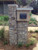 Black Urban Front Opening Zincalume Modern Mailbox Mounted In Stone  Black Urban Front Opening Zincalume Modern Mailbox Mounted In Stone
