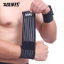 Cotton elastic wrist wrap being applied to wrist — gym bandage support for weightlifting and boxing wrist protection