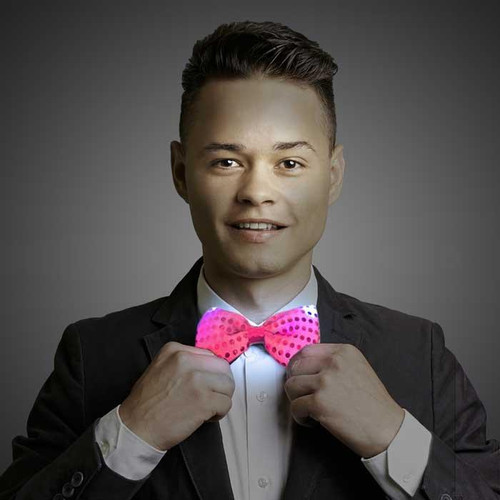 LED Sequin Bowtie, a pink illuminated sequin bowtie worn by a man in a suit.
