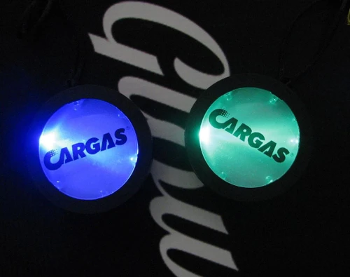 illuminated circular medallions with the CARGAS logo in blue and green lights
