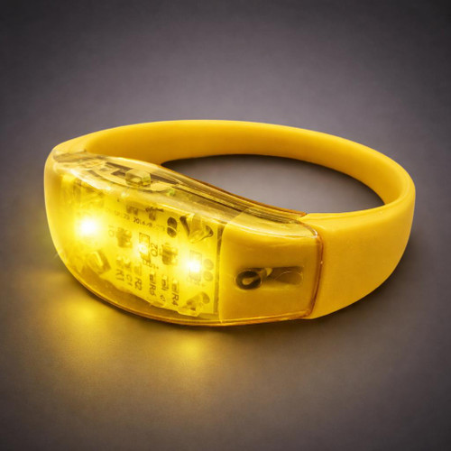 Sound Activated LED Silicone Bracelet, yellow silicone wristband with integrated LED lights that activate in response to sound.