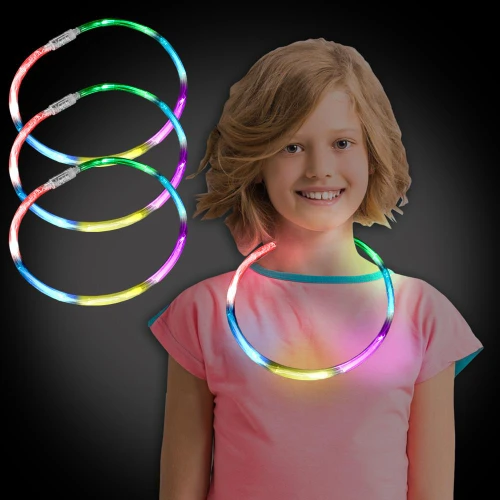 Flashing Rainbow Chaser Necklaces, colorful LED light-up necklaces worn by a young girl with shoulder-length blonde hair, brightening her pink t-shirt against a dark background.