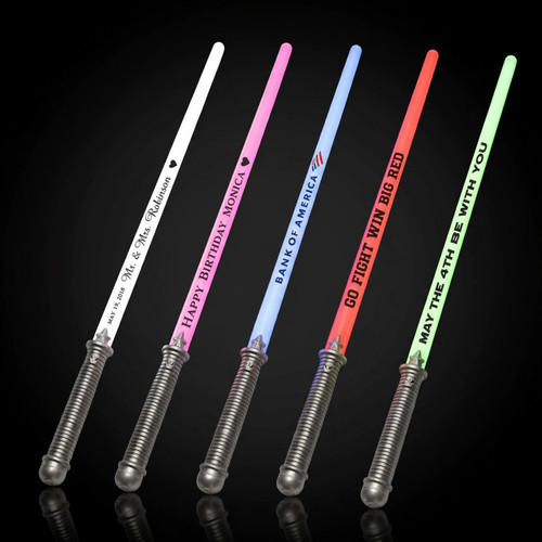 Customized LED lightsabers lit up on black background, five blades in white pink blue red green with custom text