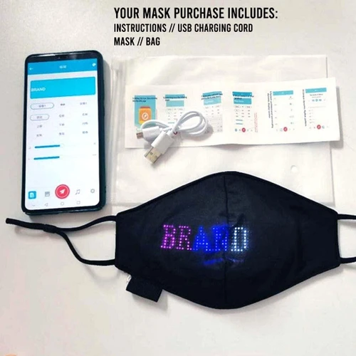black face mask with LED display showing the word 'BREATHE' in colorful lights, accompanied by a smartphone
