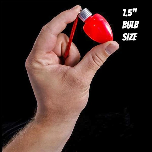 red LED bulb attached to a red string with 1.5-inch bulb size, held in hand against a black background
