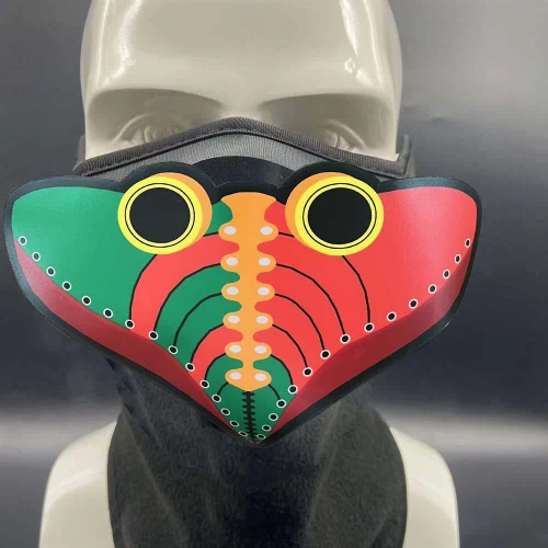 EL Panel Mask Style 110 A, colorful patterned face mask with watermelon-inspired design featuring yellow-circle accents and black eye-like details.
