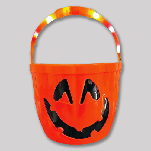 orange plastic bucket with a carved black jack-o'-lantern face and a light-up handle