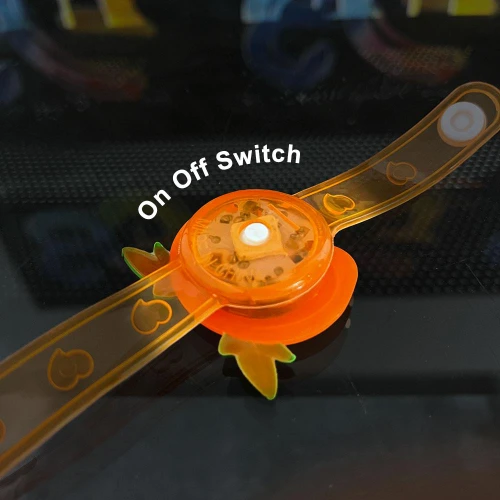 LED Flashing Pumpkin Bracelet for Kids, orange pumpkin-themed glow-in-the-dark wristband with on-off switch.