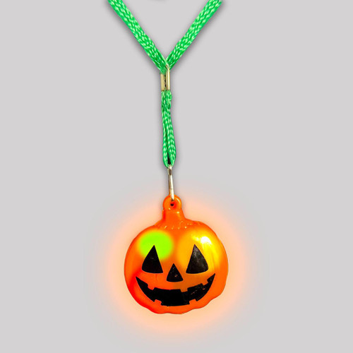 luminous orange Jack-o'-lantern pendant necklace with a green braided strap and glowing face design