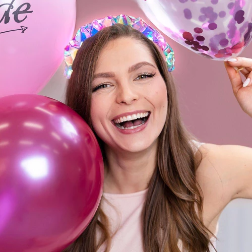 Light-Up Braided Plastic Headband, colorful iridescent braided headband worn by smiling woman with balloons at celebration.
