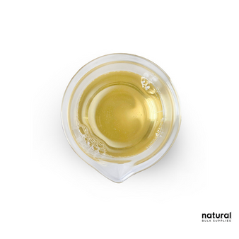 A clear, amber liquid of Cocamidopropyl Betaine displayed in a small glass beaker with subtle bubbles on the surface, placed on a plain white background, branded with the Natural Bulk Supplies logo in the corner. A clear, amber liquid of Cocamidopropyl Betaine displayed in a small glass beaker with subtle bubbles on the surface, placed on a plain white background, branded with the Natural Bulk Supplies logo in the corner.