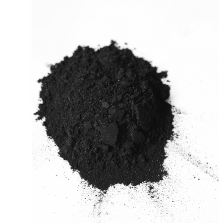 A pile of fine black Activated Charcoal Powder on a white surface A pile of fine black Activated Charcoal Powder on a white surface