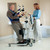A man using a lift sling for elderly patients with assistance from a woman, highlighting support in a healthcare setting. A man using a lift sling for elderly patients with assistance from a woman, highlighting support in a healthcare setting.