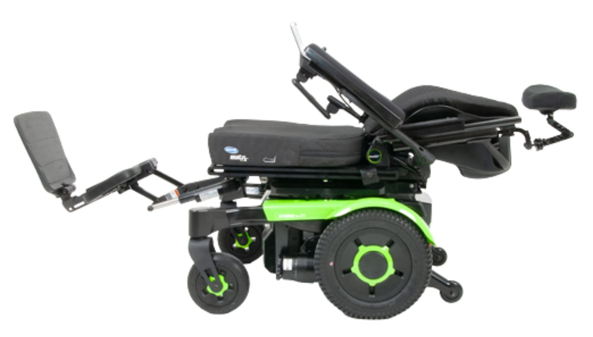 Green-accented Invacare Storm RX 20 Power Wheelchair with fully reclined backrest, adjustable footrests, cushioned rehab-style seating, and joystick controller. Designed for stability, maneuverability, and user comfort.