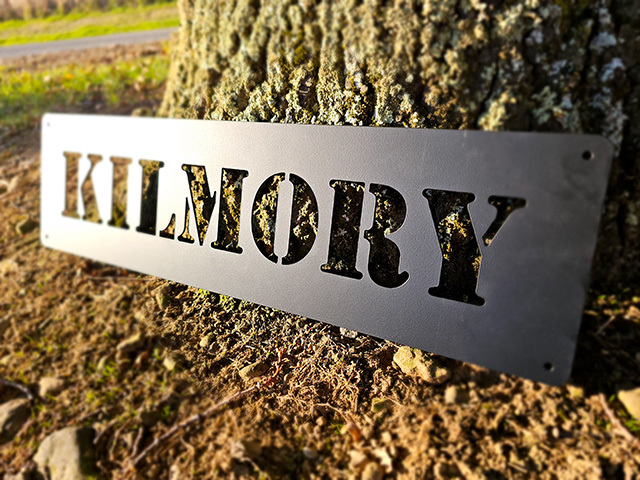 Custom Kilmory metal property sign displayed beside a tree