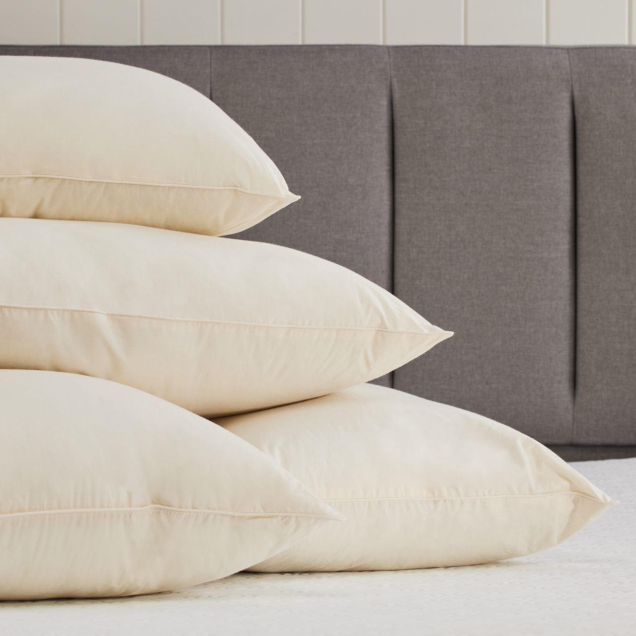 bloom organic cotton pillow stacked on bed bloom organic cotton pillow stacked on bed