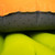 side view of the orange and charcoal pillow on an exped pad