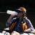 a woman on a raft drinking out of her CNOC ThruBottle with an orange cap