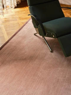 Margo rug in Peony, styled vignette with a reclining lounge chair