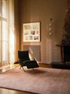 Margo rug in Peony, styled vignette with a reclining lounge chair in a sunlit room