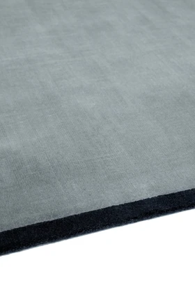 Margo rug in Lake, studio detail shot showing the graphic contrast border edge