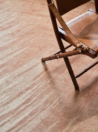 David Rockwell Splash Salmon rug, streaked salmon pink and ivory pile beneath a leather campaign chair