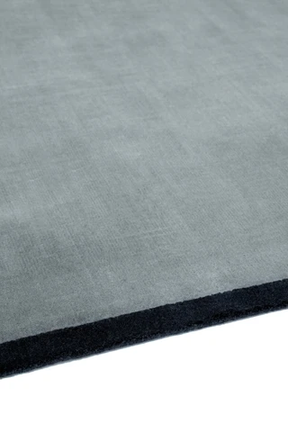 Margo rug in Lake, studio detail shot showing the graphic contrast border edge