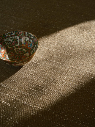 Vara rug in Olive, styled vignette with a cloisonne bowl