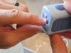 Image: Lil Nipper automatic nail clipper, cutting a nail