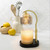 Elevate your home decor with the Mercury Glass Candle Warmer Lamp. With its gold mercury glass shade, elegant adjustable gold stem, and sleek black base, it brings timeless sophistication to any room. Its top-down warming technology safely melts candles flame free for even, long lasting fragrance release, making it a stylish, functional statement piece.