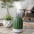 Bring a touch of nature indoors with the Cactus USB Ultrasonic Diffuser. This chic botanical accent is finished in soft celadon green with embossed details.