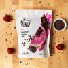 Theo Chocolate Roasted Cocoa Nibs on counter with berries and loose nibs