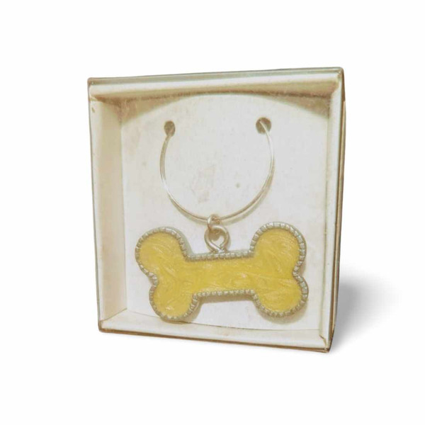 Dog charm shaped like a bone with "diamonds" along the border