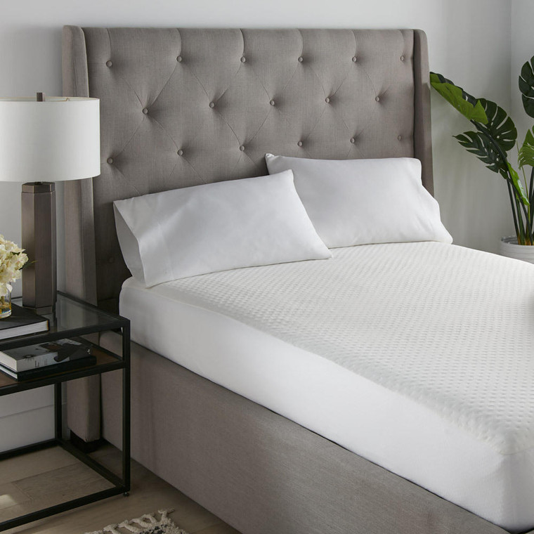 SilverTemp Clean Sleep Waterproof Cooling Mattress Protector by SleepCare, white, on a gray bed.
