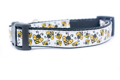 Glittery gold bees on a black nylon.