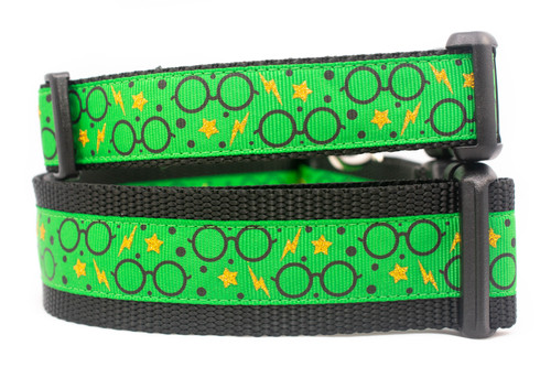Green dog collar with a black nylon. The collar has a repeating pattern of black glasses, gold stars, and lightning bolts.