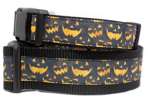 Black dog collar with a pattern of orange jack-o'-lantern faces.