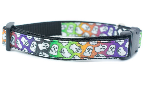 A black and white dog collar with a rainbow gradient and a pattern of white ghosts. 