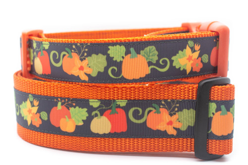 Orange dog collar with a pumpkin and leaf pattern.