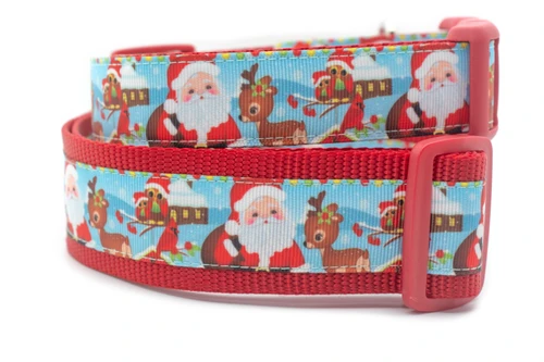 A red dog collar with a blue and white Christmas themed pattern. The pattern features Santa Claus and reindeer.