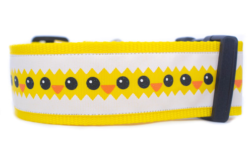A yellow dog collar with an eggshell border and peeping chicks.