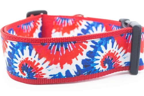 A red, white, and blue dog collar with a tie dye pattern on 2 inch wide red nylon.