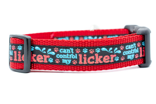 Dog collar with 1 inch wide red nylon and black ribbon with red and blue glittery pawprints and words "can't control my licker". 