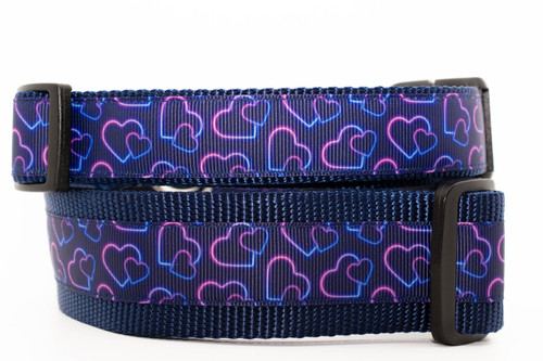 Collar with navy blue nylon and navy neon hearts on a navy background.  Top is 1 inch wide and bottom is 1.5 inch wide.  Collars pictured are buckle style. Collar with navy blue nylon and navy neon hearts on a navy background.  Top is 1 inch wide and bottom is 1.5 inch wide.  Collars pictured are buckle style.