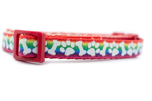 cat collar with red nylon and a glow in the dark paw and bone design on rainbow ribbon cat collar with red nylon and a glow in the dark paw and bone design on rainbow ribbon